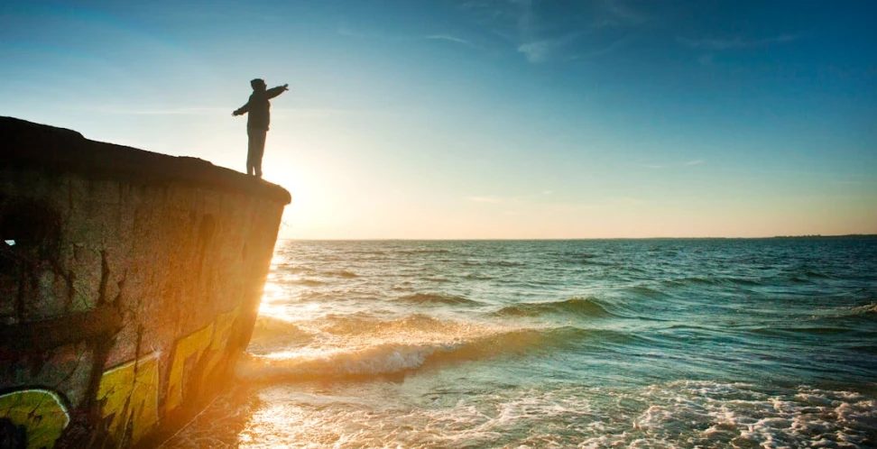 man looking into the ocean